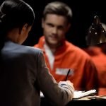 Female defense attorney writing accused prisoners statements for court, advocacy Female defense attorney writing accused prisoners statements for court, advocacy